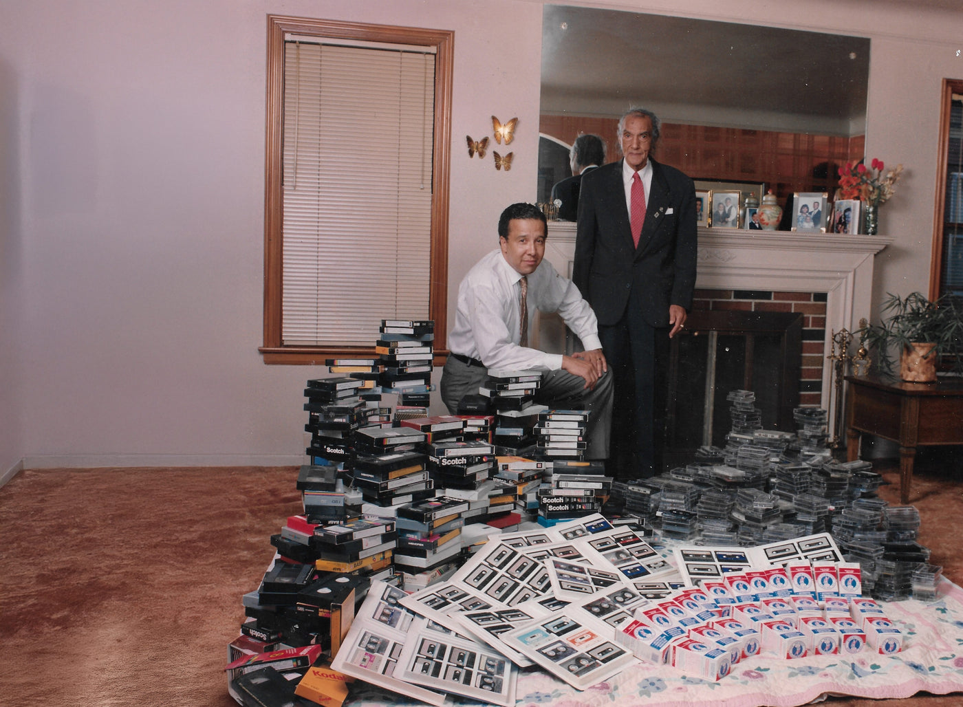 Frank (sitting) and Doug Sewell (kneeling) next to hundreds of testimonials and boxes of Ringmaster Rubbing Oil.